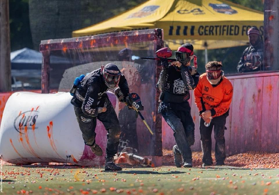 Player sprinting past an OPS bunker during a point on the speedball field