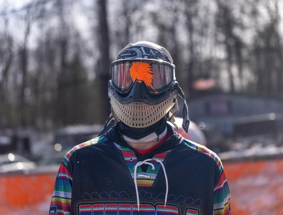 Player with orange paint splat on goggles at Matts Outback Paintball