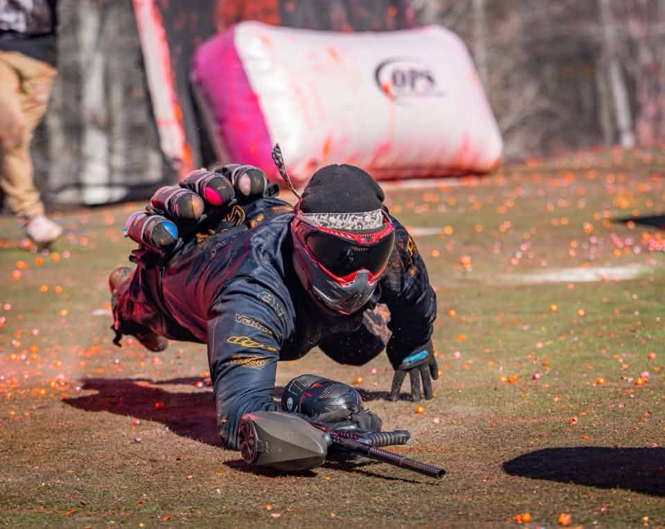 Player diving prone for a bunker with pods and marker on the OPS field